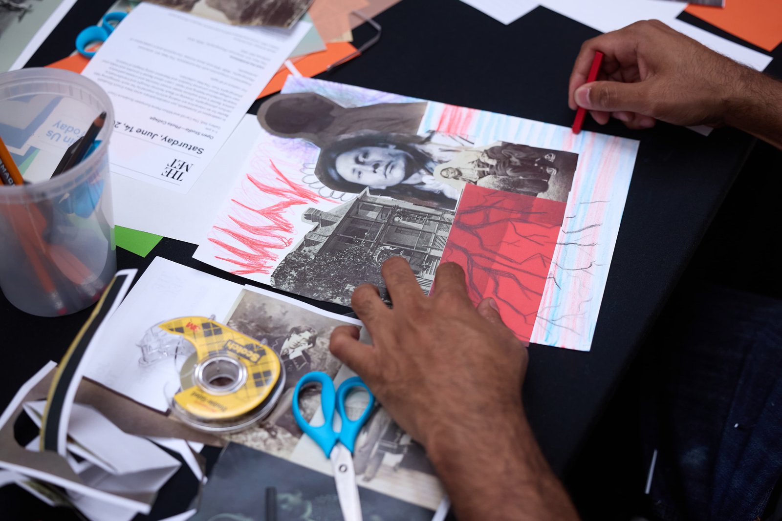 Hands of a program participant making a collage.